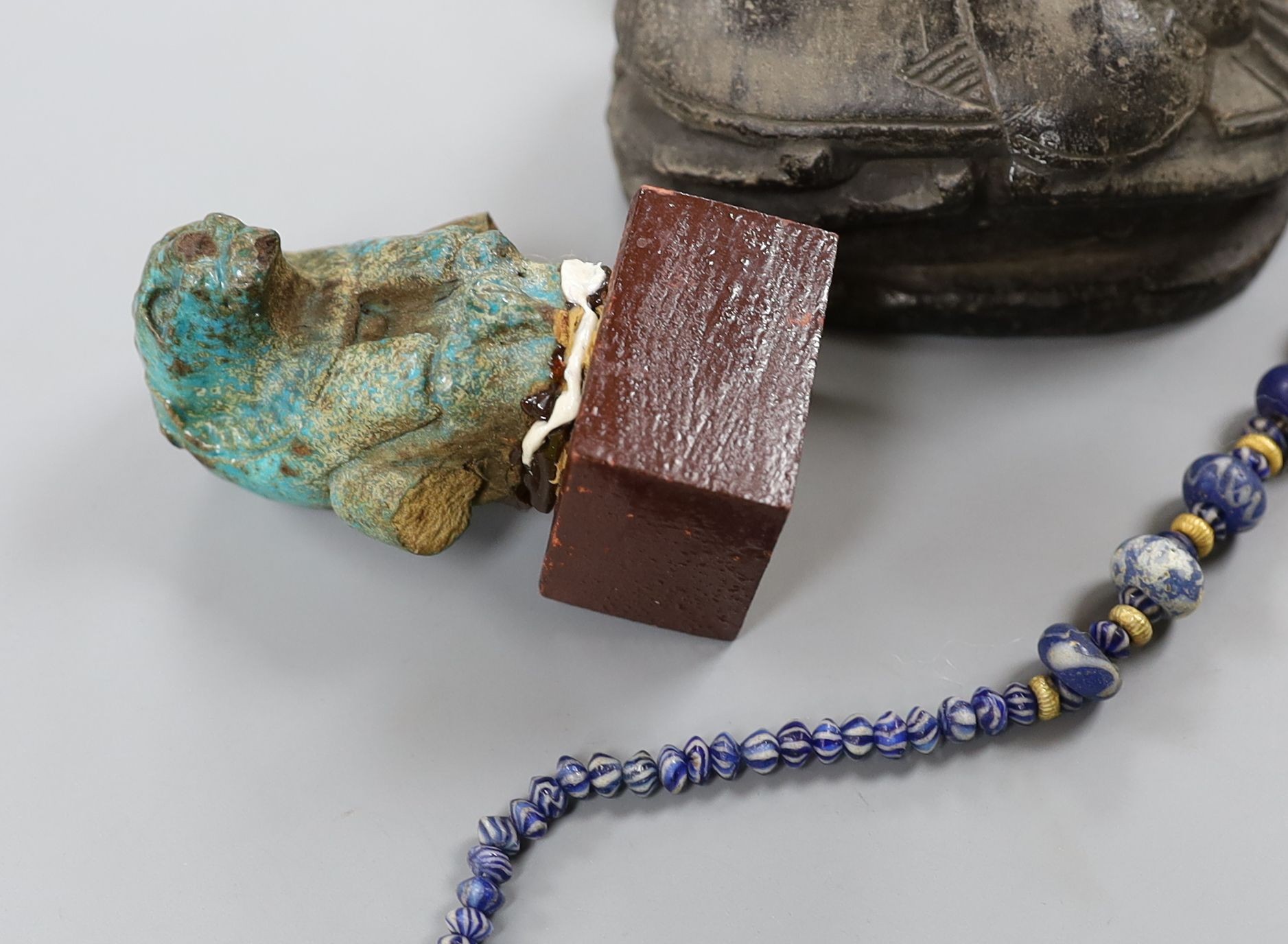 A small collection of Egyptian artefacts including necklace, scarabs, rings and a later scarab, part of the Josephine Dubois collection